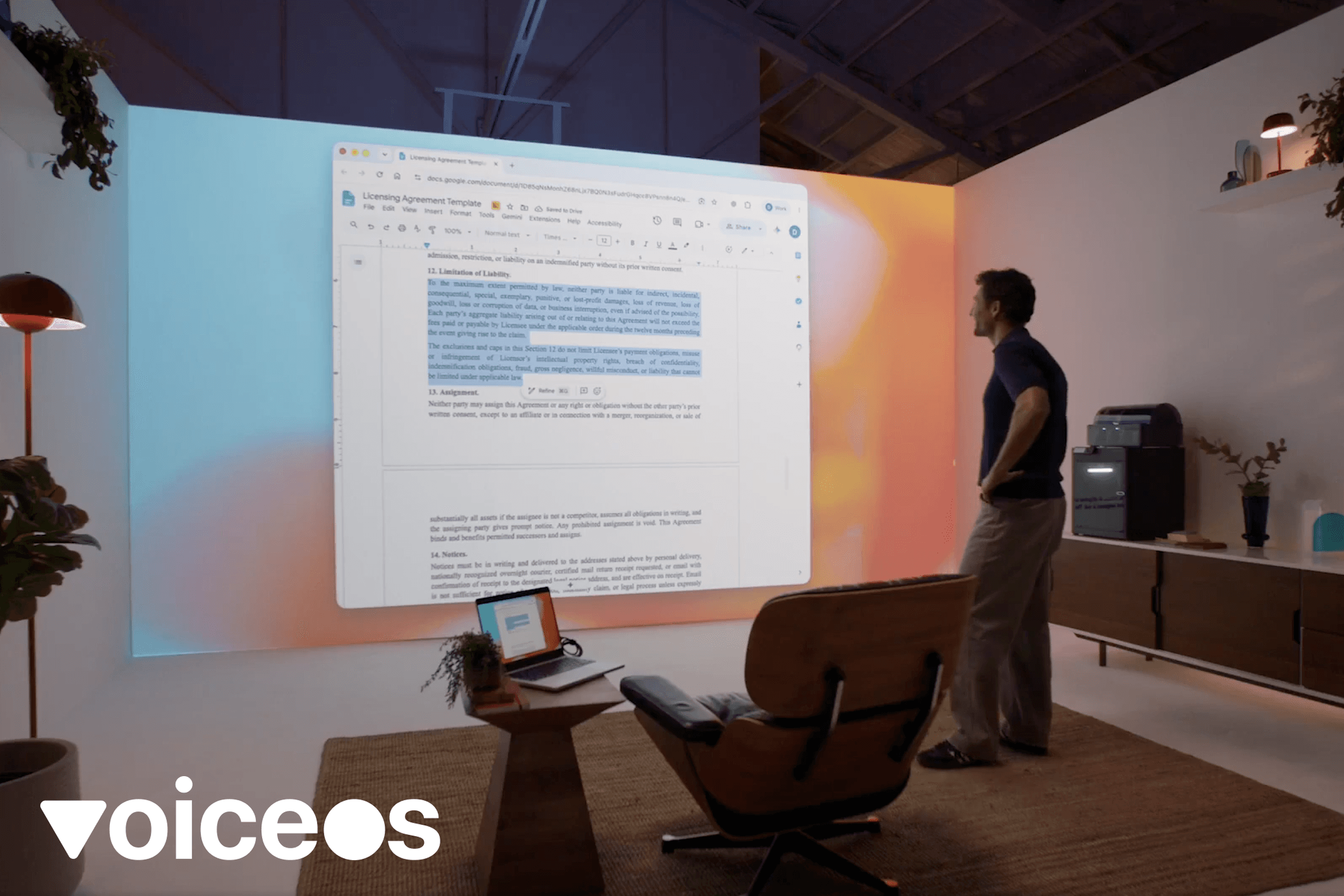 A person speaks toward a projected computer workspace in the GPT-6 Astra launch video, with the VoiceOS logo at bottom left.